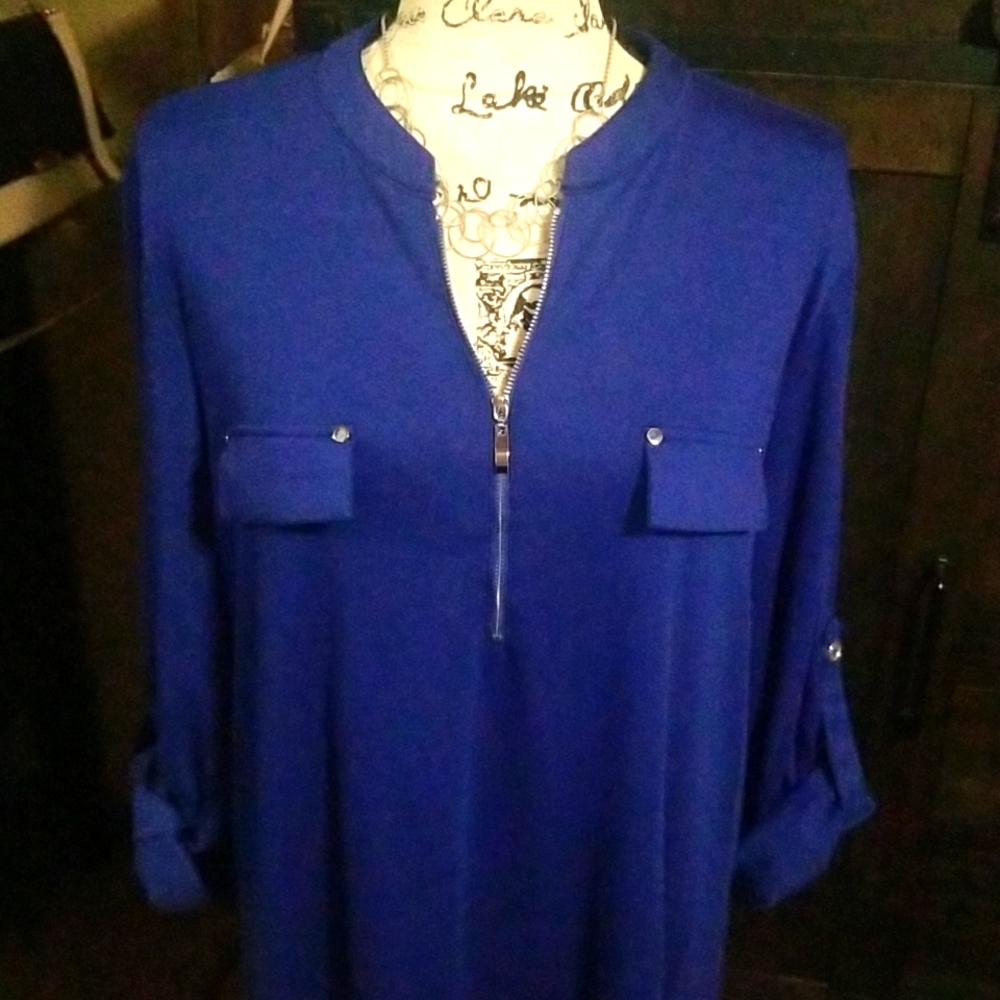 Royal blue top with silver button and zipper details.